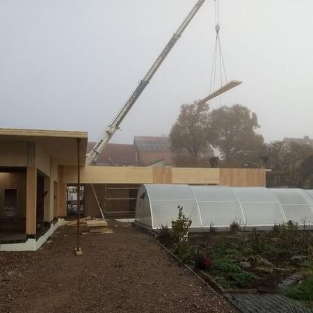 Montage eines Dachteils mit Kran bei nebligem Wetter - Wohnhaus II